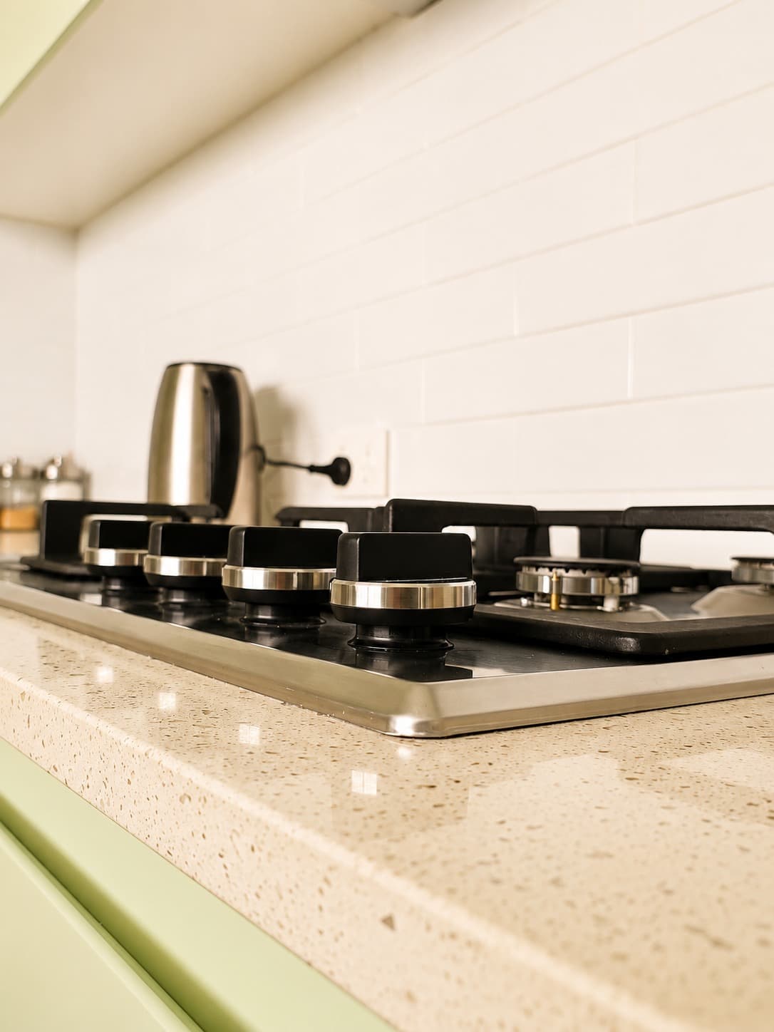 Cooktop and terrazzo benchtop detail in a kitchen built by A&E Joinery