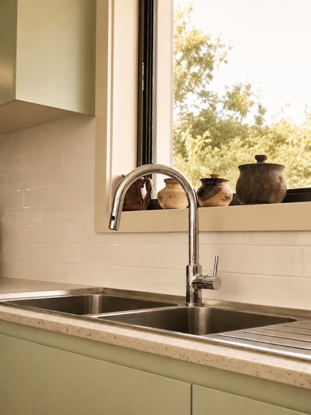 Kitchen sink and window detail with terrazzo benchtop