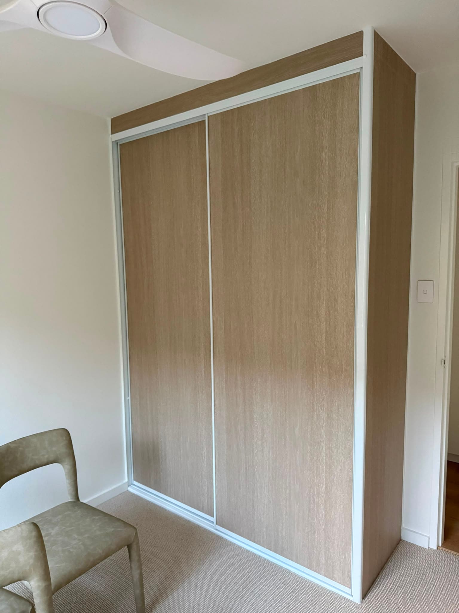 Four-panel mirrored sliding door wardrobe by A&E Joinery