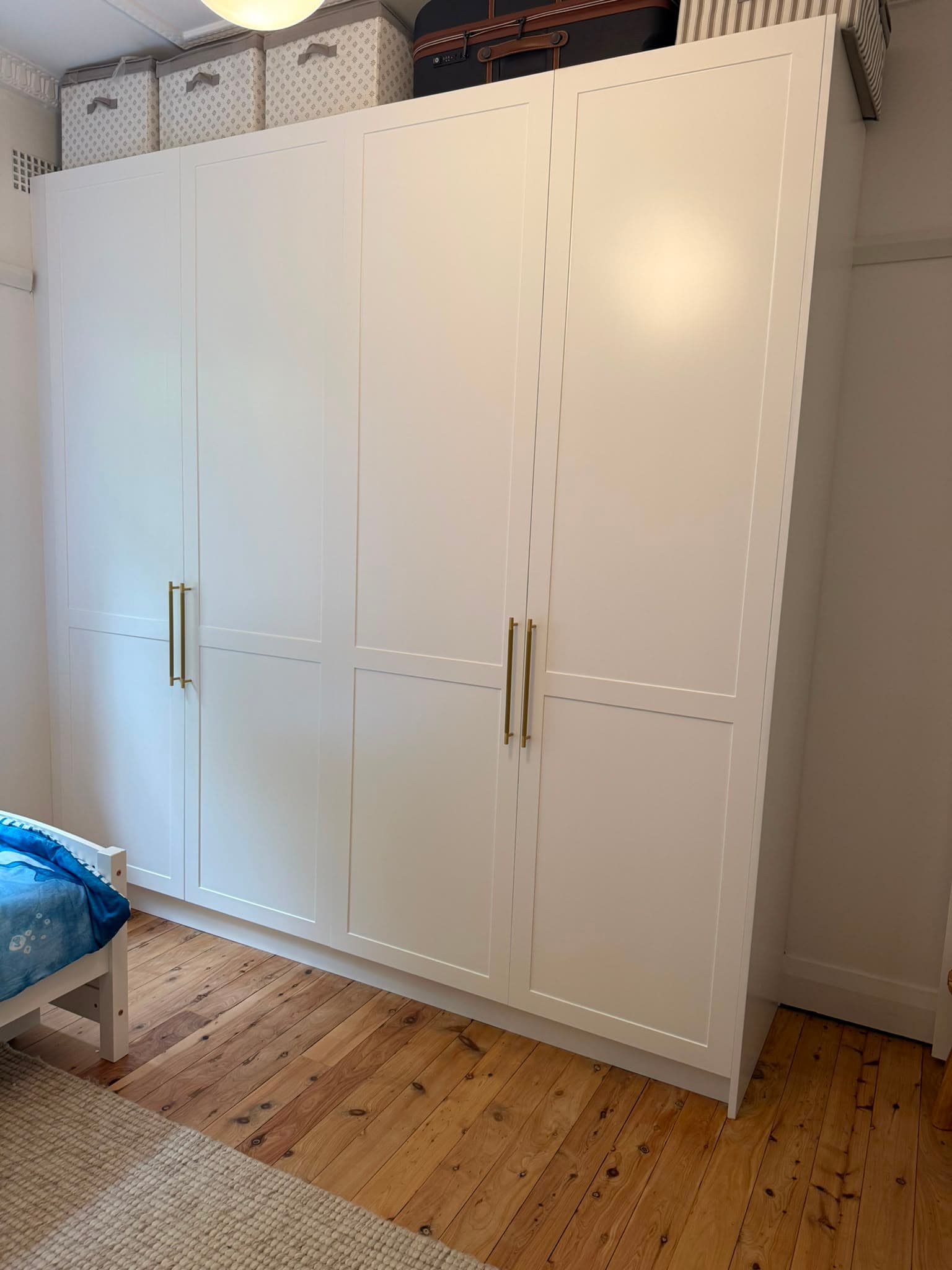 Four-door white shaker wardrobe with brass pull handles